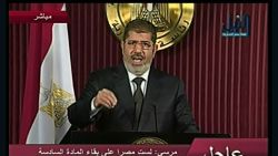 Egyptian president Mohammed Morsy addresses the nation via television on Thursday, December 6.