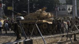 Egyptian army soldiers set up barbed wire barricades and deploy tanks outside of the Egyptian presidential palace in Cairo on December 6, 2012.