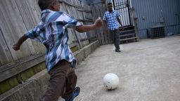 A Bangladeshi boy plays soccer with his father in Baltimore, Maryland. The boy was attacked and mutilated in Dhaka in 2010 and was later brought to the U.S., where doctors at Johns Hopkins Children's Center agreed to operate on him for free.