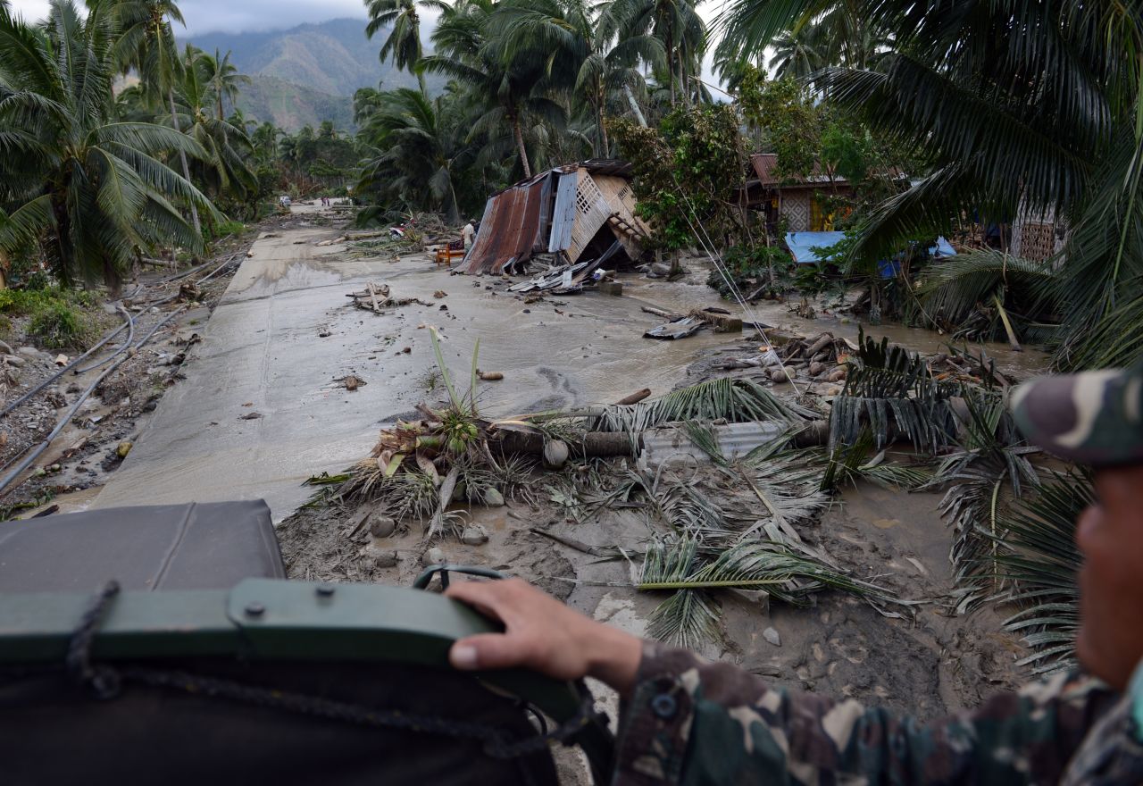 Philippine soldiers patrol New Bataan, in the Compostela Valley, Philippines, as they look for flood survivors on Wednesday, December 5.