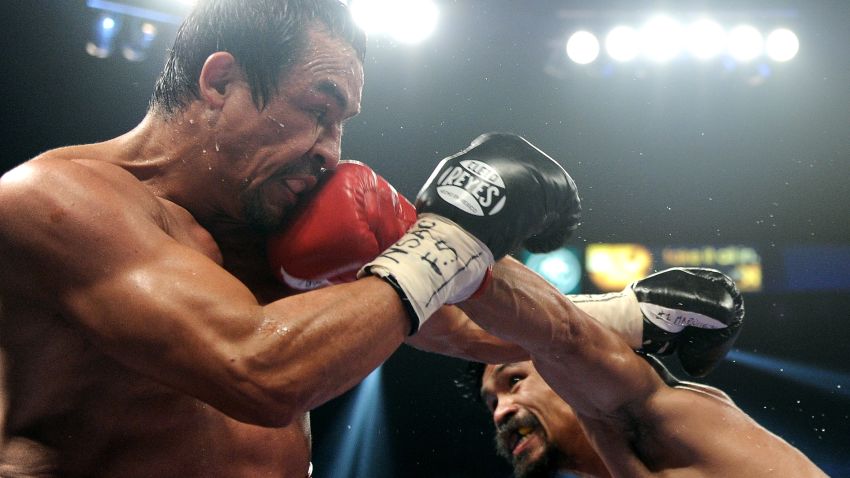 Manny Pacquiao connects with a left to the head of Juan Manuel Marquez during the WBO world welterweight title fight at the MGM Grand Garden Arena on November 12, 2011.
