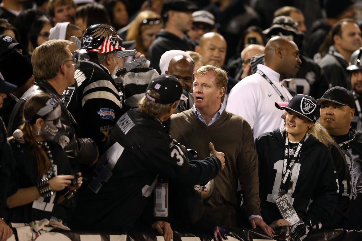NFL commissioner Roger Goodell stands with fans in the "Black Hole" during the game between the Oakland Raiders and the Denver Broncos on Thursday.