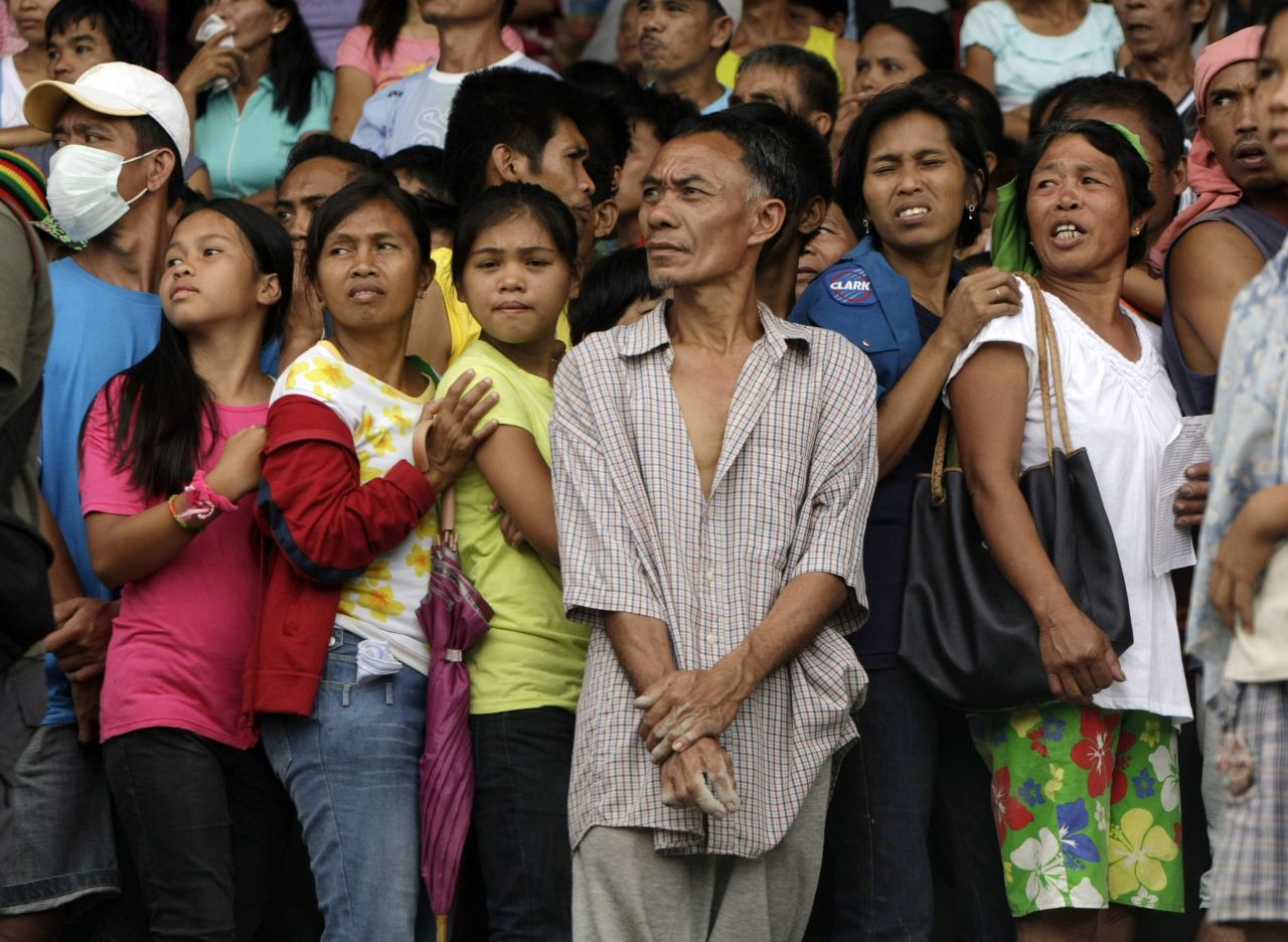 A crowd of Filipino flood victims wait for relief goods inside a sports complex that has been turned into a temporary evacuation center in New Bataan, Compostela Valley, on December 7.