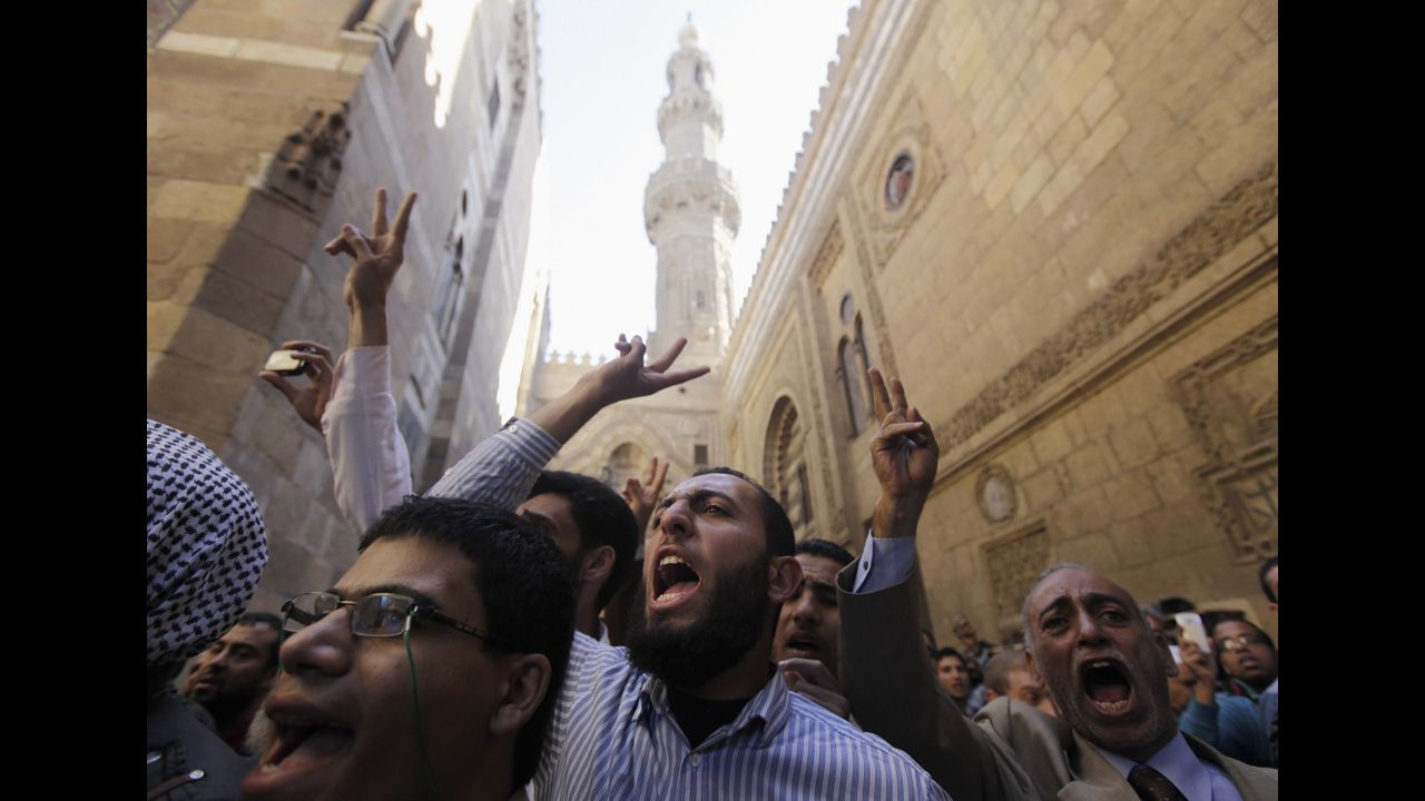 Supporters of Egyptian President Mohamed Morsy and members of the Muslim Brotherhood shout during the funerals of fellow Morsy supporters at Al-Azhar mosque in Cairo on December 7.