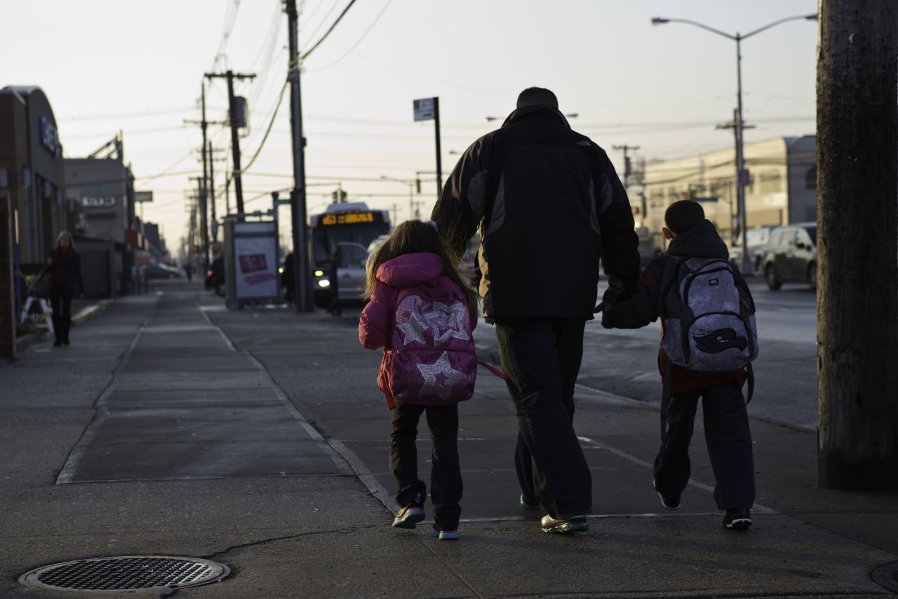 Joe Panetta walks his youngest kids to a bus stop before school.<br />