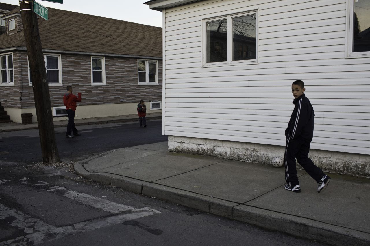 Ryan Panetta and his siblings plays soccer outside his family's home in the Broad Channel section of Queens. They kids and their mom tried to stay in their house during the storm, but escaped to a neighbor's second story.<br />