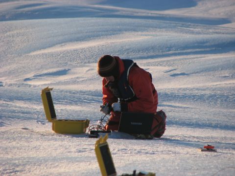 Anna Crawford of Carleton University sets up instruments to measure thickness of an ice island. Mueller says that in 2011 alone, 3 billion tons of ice broke away from Canada's major ice shelves on the northern coast of Ellesmere Island.