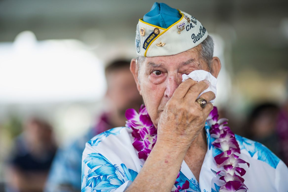 Pearl Harbor survivor Victor Miranda wipes his eyes during a commemorative ceremony in Pearl Harbor, Hawaii.