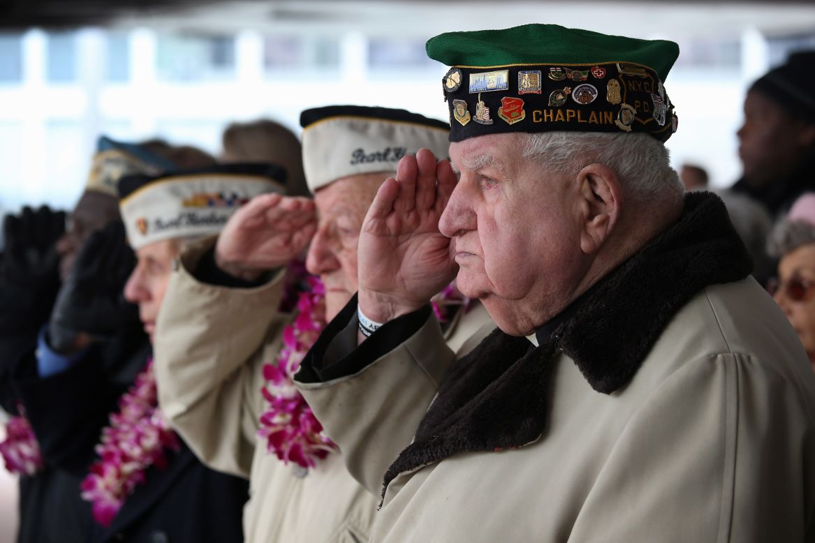 Survivors salute during a memorial service in New York.