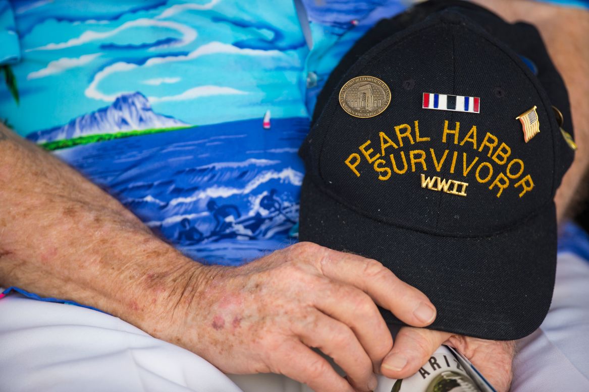 Pearl Harbor survivor Paul Kennedy of Indiana holds his hat during the singing of the National Anthem in Pearl Harbor, Hawaii.