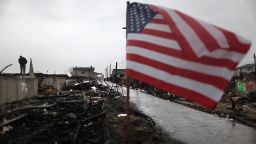 Dennis Kane stands above the charred remains of his destroyed home in the hard hit Breezy Point neighborhood on December 7, 2012 in the Queens borough of New York City. Breezy Point, home to many New York City firefighters and police, lost 111 homes in a fast moving fire during Superstorm Sandy with many more homes severely damaged from flooding. 