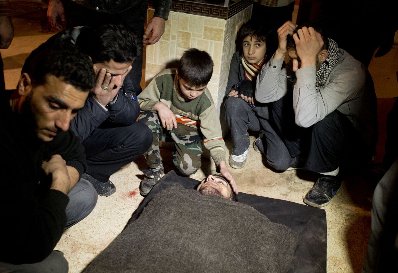Syrians mourn a fallen rebel fighter at a rebel base in the al-Fardos area of Aleppo on Saturday, December 8.