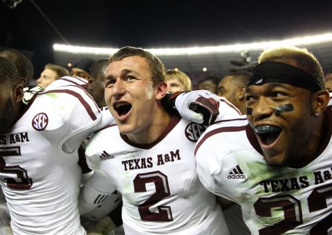 Manziel, wide receiver Kenric McNeal, left, and defensive back Dustin Harris, right, celebrate after beating the Alabama Crimson Tide on November 10 in Tuscaloosa, Alabama.
