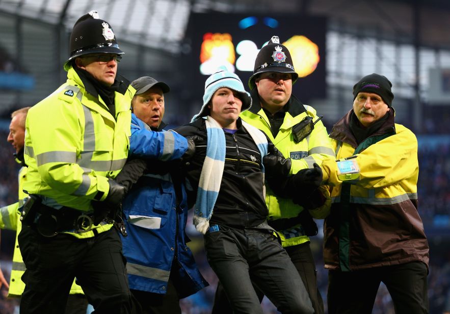 Police intervened to eject the invader, and the Greater Manchester force also announced after the match that another man was arrested inside City's Etihad Stadium on suspicion of chanting racist abuse.