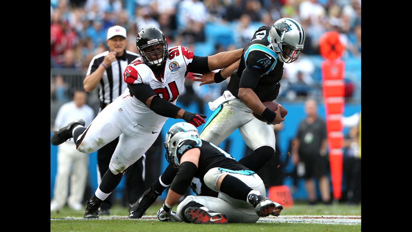 Panthers quarterback Cam Newton breaks away from Corey Peters of the Falcons on Sunday.