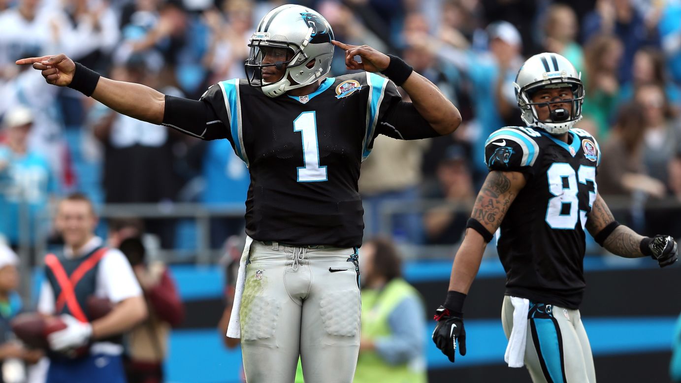 Cam Newton of the Panthers signals a first down as teammate Louis Murphy watches on Sunday.