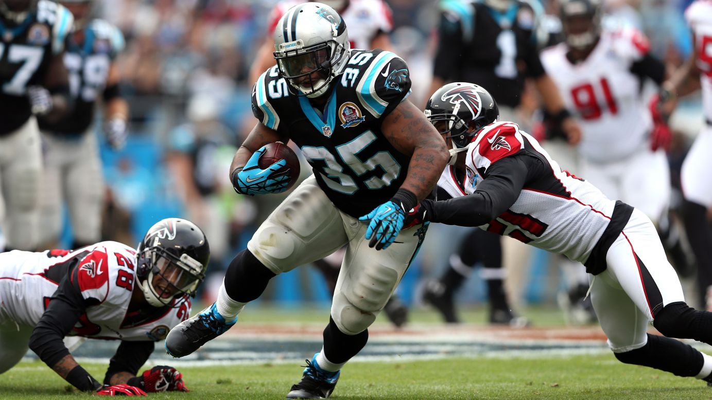 Falcons teammates Chris Owens and Thomas DeCoud tackle Mike Tolbert of the Panthers on Sunday.
