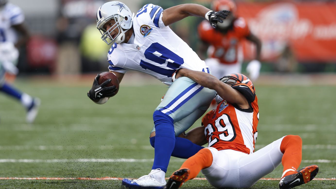 Miles Austin of the Cowboys gets tackled by Leon Hall of the Bengals on Sunday.