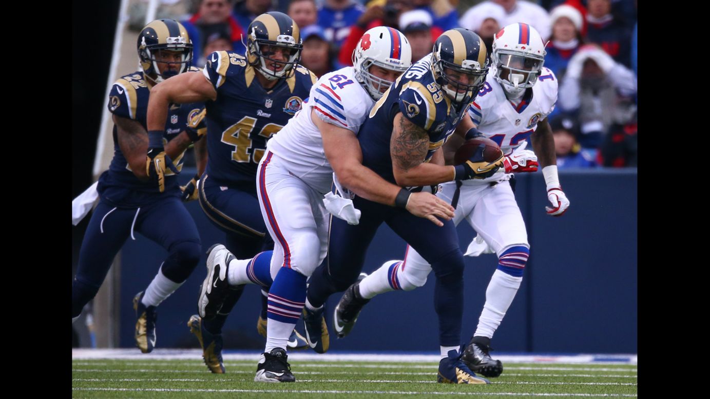 Rams linebacker James Laurinaitis picks up a fumble as he is tackled by David Snow of the Bills after the Bills turned the ball over on Sunday.