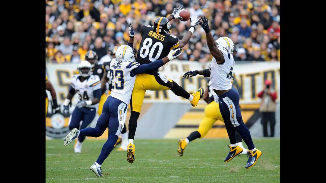 Steelers wide receiver Plaxico Burress makes a catch between Quentin Jammer and Takeo Spikes of the Chargers on Sunday.