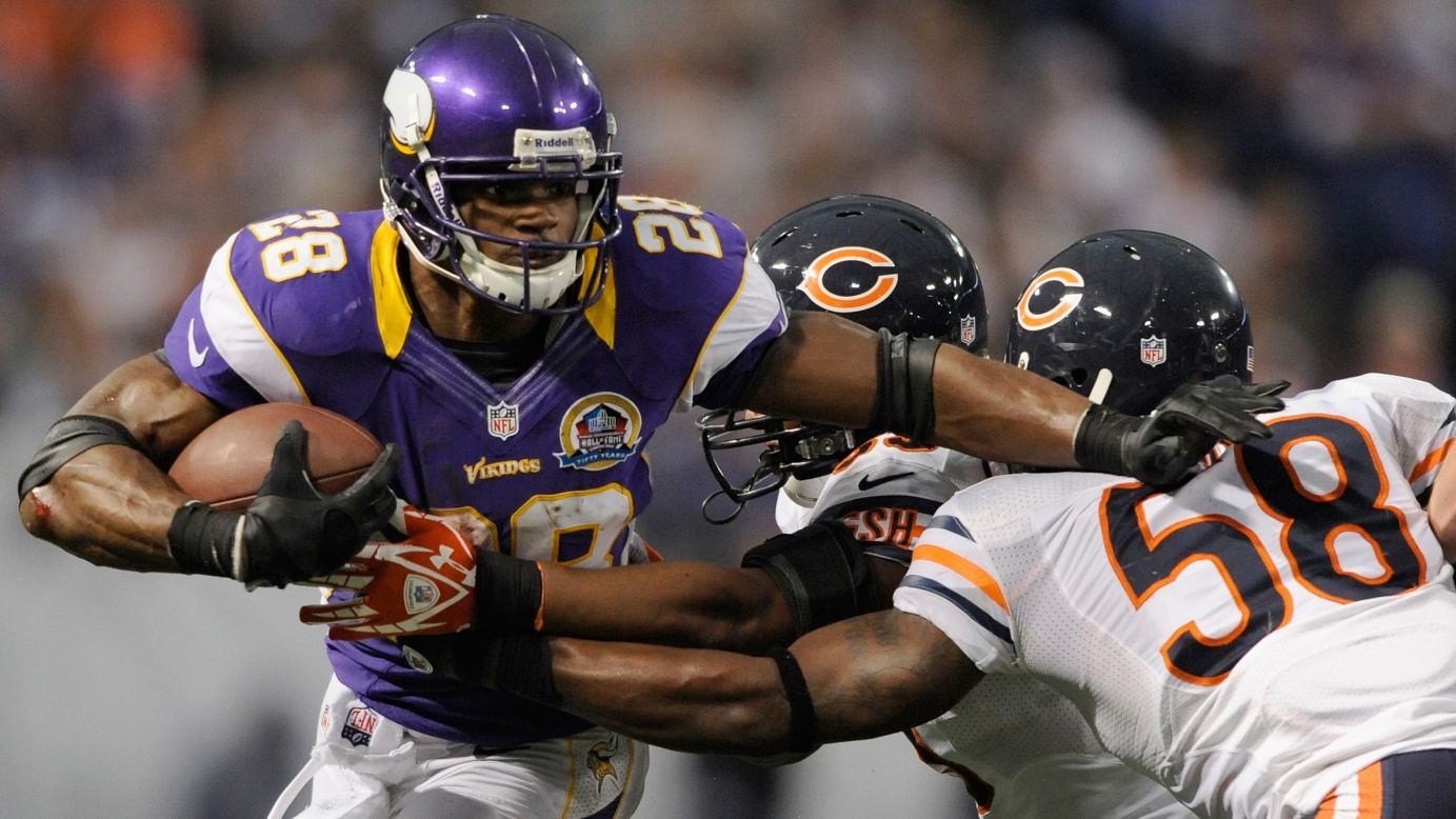 Minnesota Vikings running back Adrian Peterson carries the ball against No. 53 Nick Roach and No. 58 Dom DeCicco of the Chicago Bears during the fourth quarter on Sunday, December 9, at Mall of America Field at the Hubert H. Humphrey Metrodome in Minneapolis, Minnesota. The Vikings defeated the Bears 21-14. 