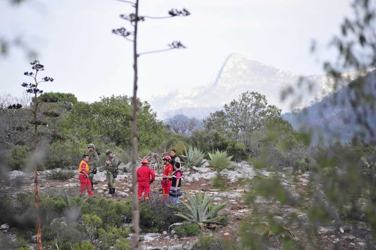 Soldiers and civil protection personnel inspect the perimeter of the crash site. The plane took off from Monterrey, Mexico, and lost contact with air traffic controllers. 
