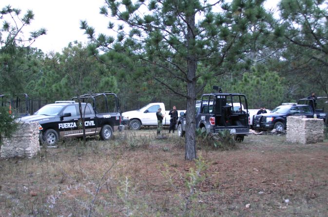 Security members work at the site of the plane wreckage.