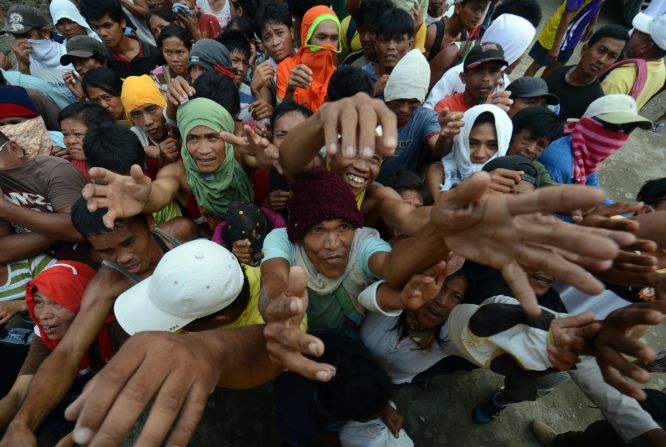 Victims of Typhoon Bopha jostle for position as they beg for relief food in New Bataan in Compostela Valley province on Sunday, December 9. 