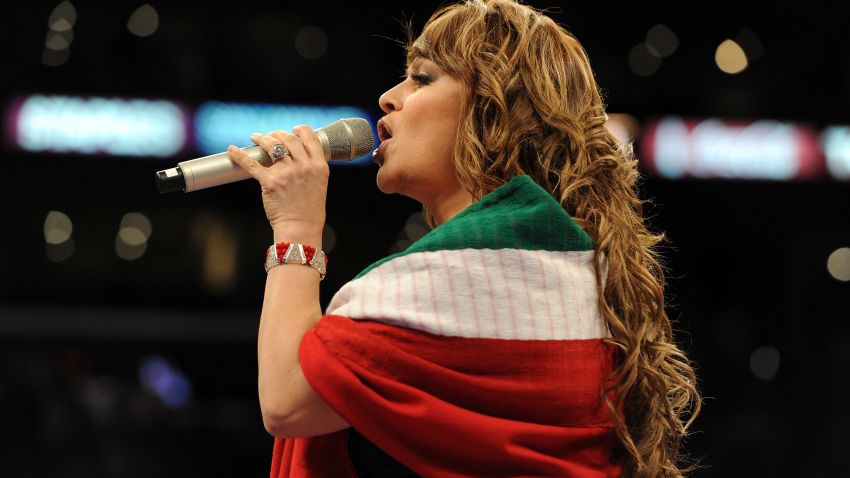 LOS ANGELES, CA - SEPTEMBER 18: Jenny Rivera sings the Mexican national anthem before the Middleweight bout against Shane Mosley and Sergio Mora at Staples Center on September 18, 2010 in Los Angeles, California.  (Photo by Harry How/Getty Images)