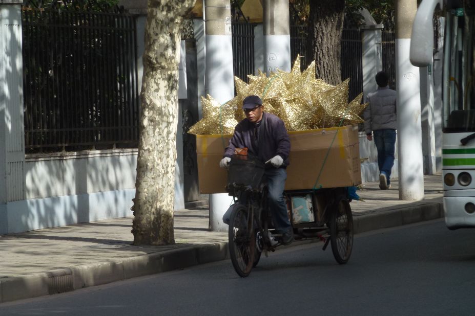 Dutch iReporter <a href="http://ireport.cnn.com/people/Irenere">Irene Reijs</a>, captured this image of a man delivering Christmas decorations by bike in her adopted home of Shanghai, China. "Christmas is not a Chinese tradition, but much of our decorations are made in China," she said. 