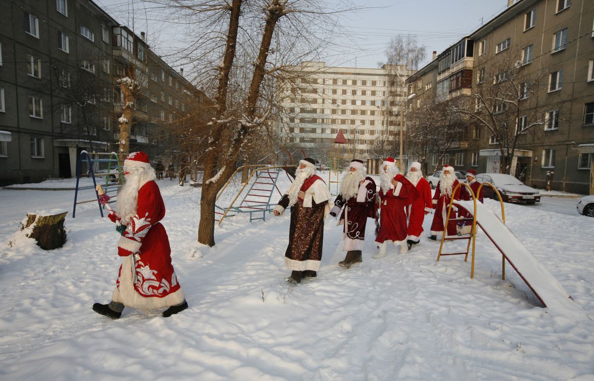 Costumed participants of the annual "Best Father Frost" contest from different city districts make their way through a courtyard in Krasnoyarsk, Russia, on Monday, December 10.