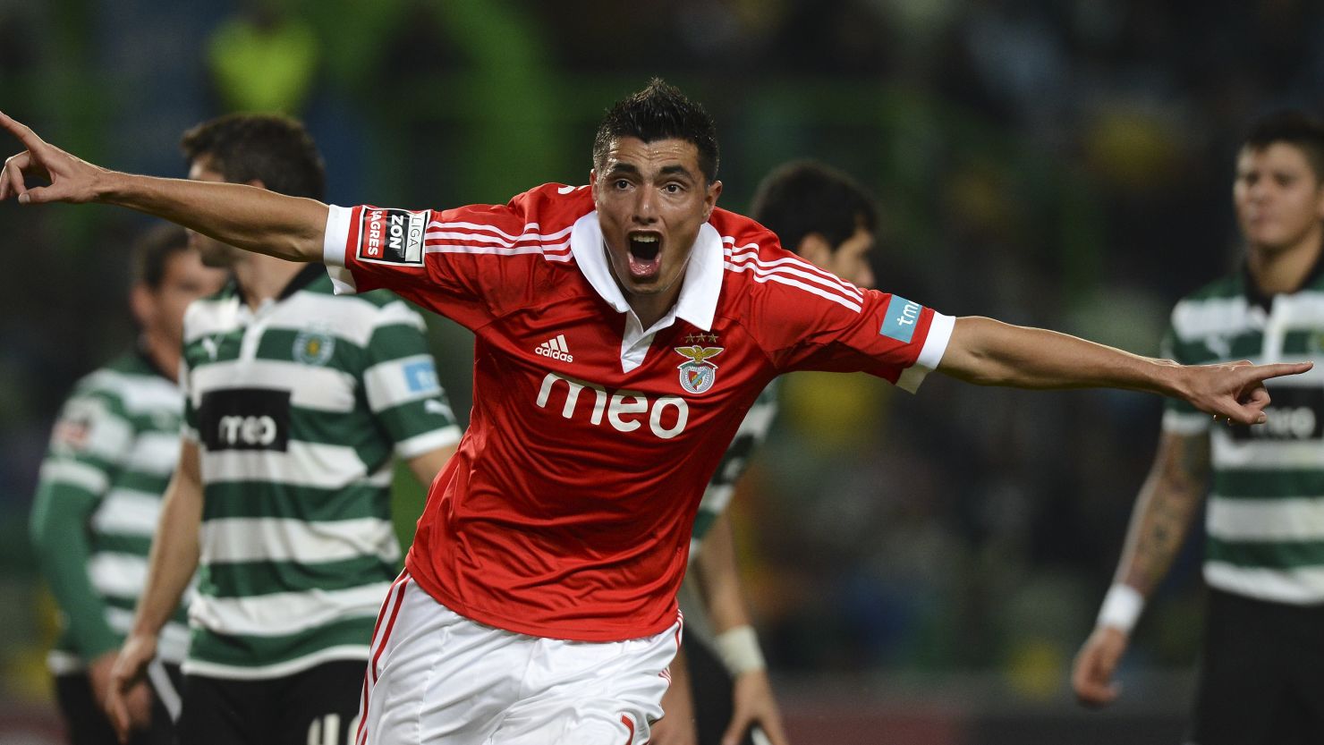 Paraguayan striker Oscar Cardozo celebrates as he aids Benfica's comprehensive defeat of struggling city rivals Sporting. 