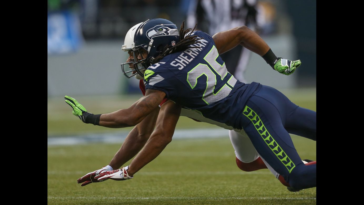 Cornerback Richard Sherman of the Seahawks defends on a pass intended for wide receiver Larry Fitzgerald of the Cardinals on Sunday.
