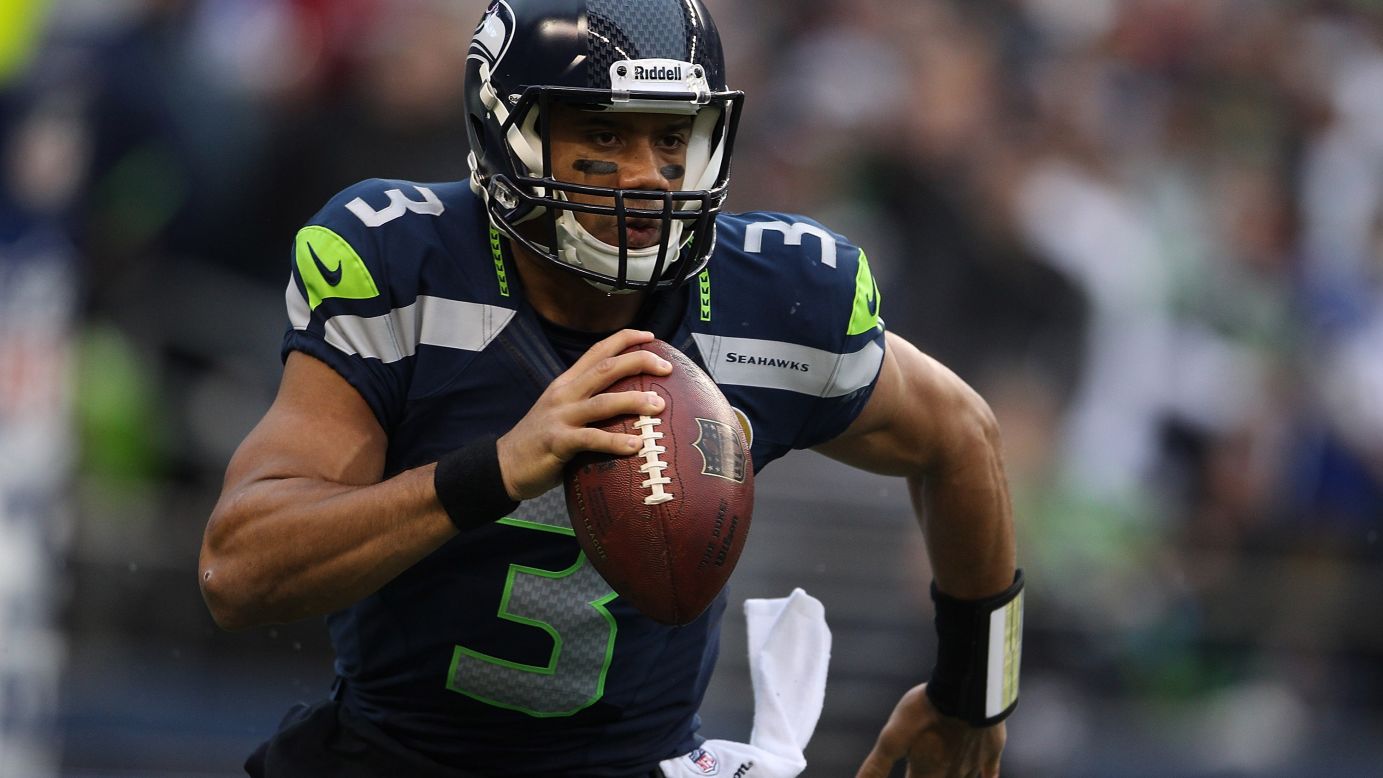 Seahawks quarterback Russell Wilson runs out of the pocket against the Cardinals in the first quarter on Sunday.