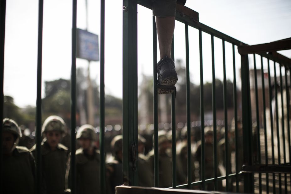 A young protester climbs atop a barricade erected by the Egyptian army on December 11. There were no incidents of violence and soldiers held the line as a couple of hundred protesters pressed up against waist-high crowd barriers.