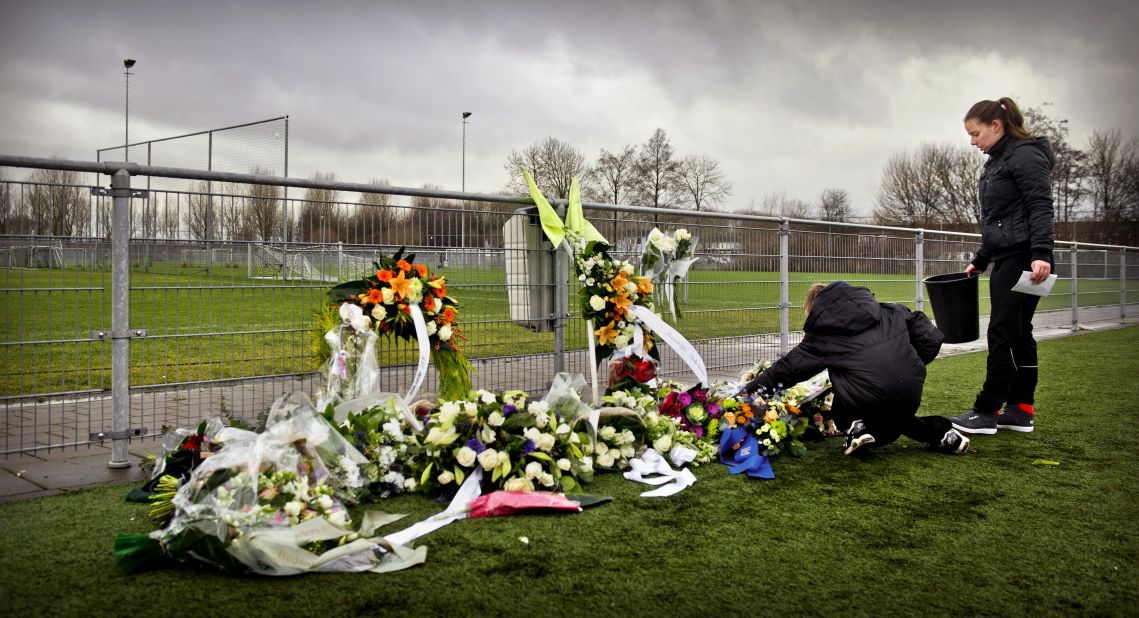 People lay flowers for Nieuwenhuizen at the Buitenboys clubhouse in Almere on December 9, 2012. Eight people have been arrested in connection with the attack, which came following a match against Amsterdam's Nieuw  Sloten.