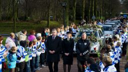 Members of Dutch football club SC Buitenboys pay respect to Richard Nieuwenhuizen as the hearse carrying his body arrives at the crematorium in Almere on December 10.