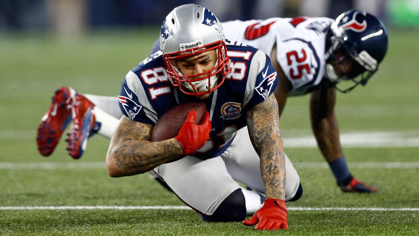 Aaron Hernandez of the New England Patriots catches a pass in front of Kareem Jackson of the Houston Texans on Monday.