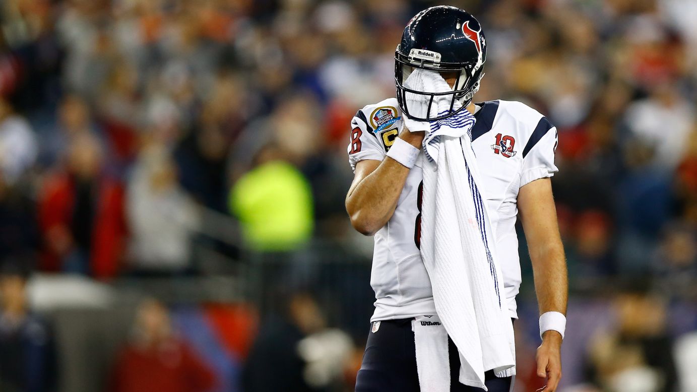 Texans quarterback Matt Schaub wipes his face while taking on the Patriots on Monday.