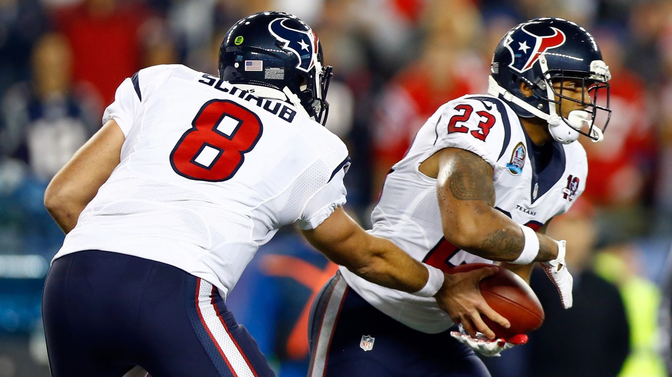 Texans quarterback Matt Schaub hands the ball off to running back Arian Foster during Monday's game against the Patriots.