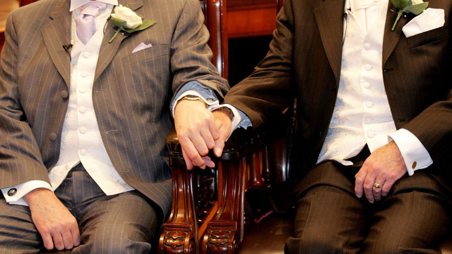 (File photo) A couple holds hands in Brighton before becoming one of the first same sex couples to form legal civil partnerships in England.