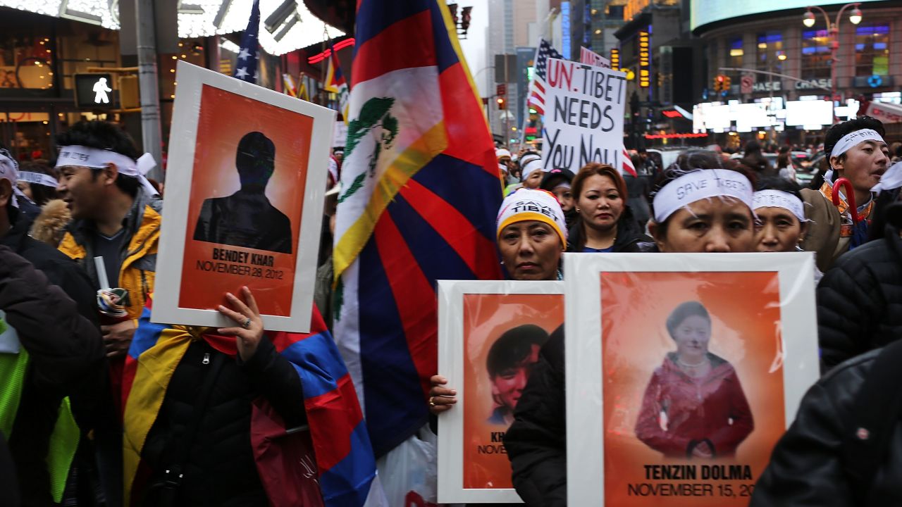 Protesters carrying posters of Tibetans who have self-immolated walk to the United Nations in New York on December 10, 2012.