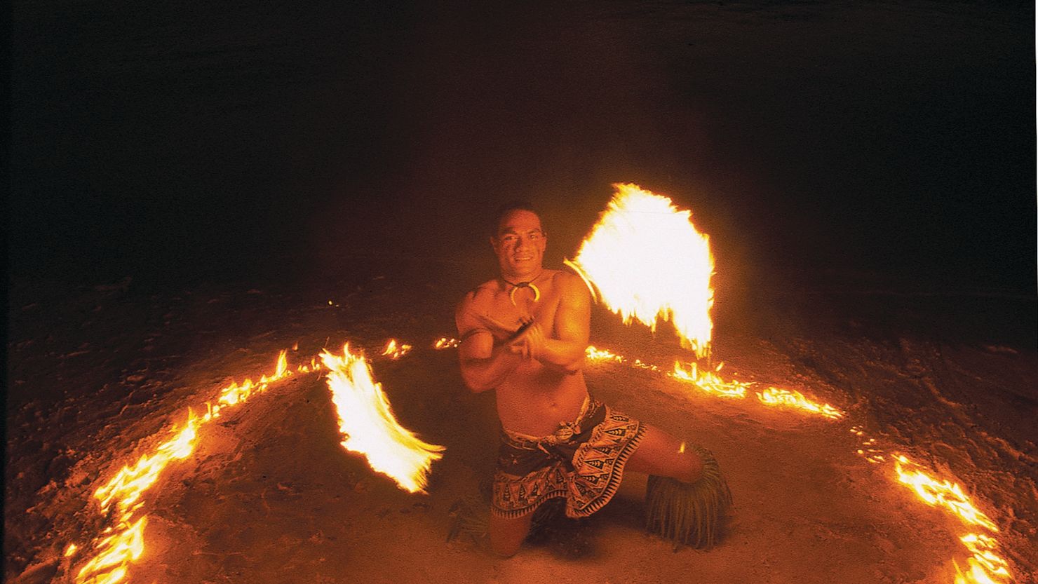 A fire dancer performs on a beach in Samoa.