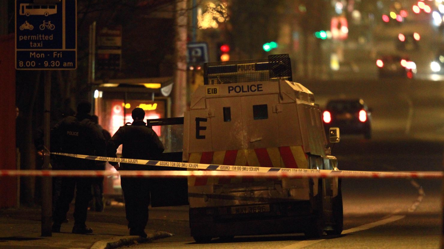 Police patrol the area of a petrol bomb attack outside MP Naomi Long's office in east Belfast, Northern Ireland, on Monday. 