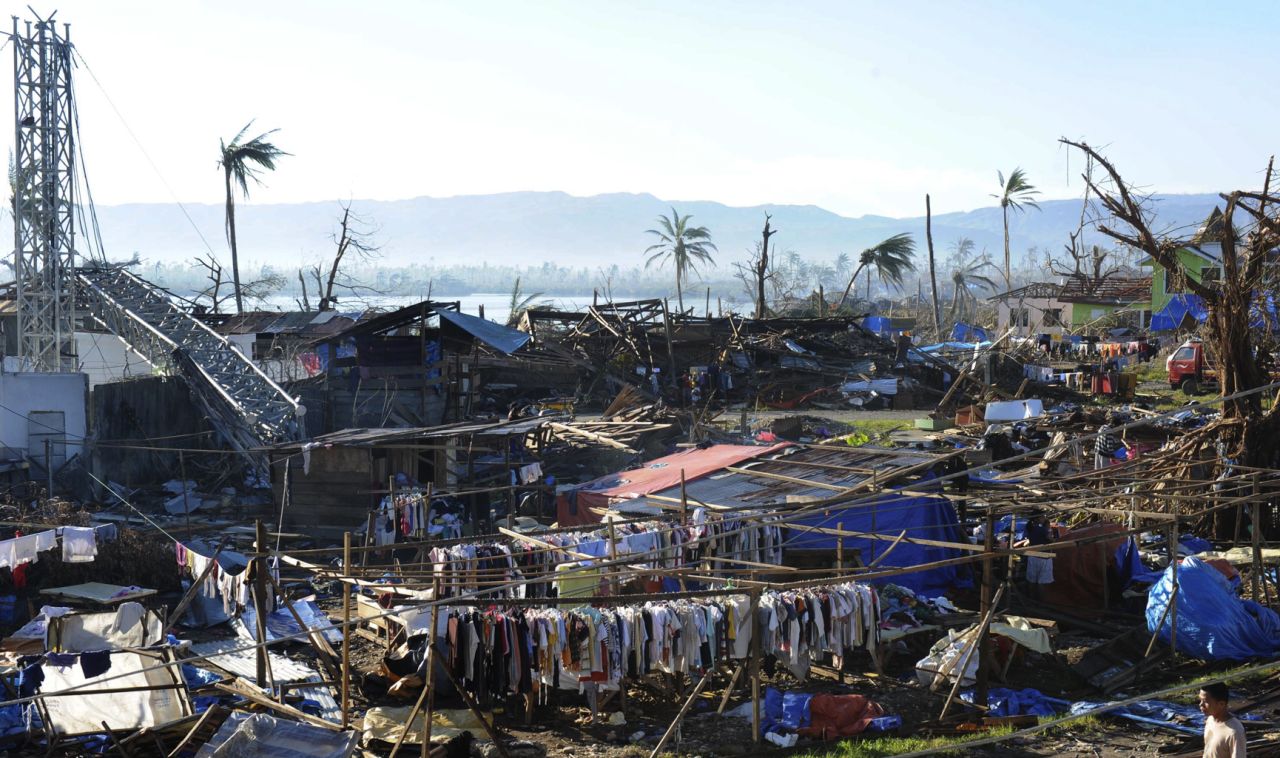 Clothes hang next to destroyed houses and toppled trees in the town of Cateel, Davao Oriental province, on December 11.