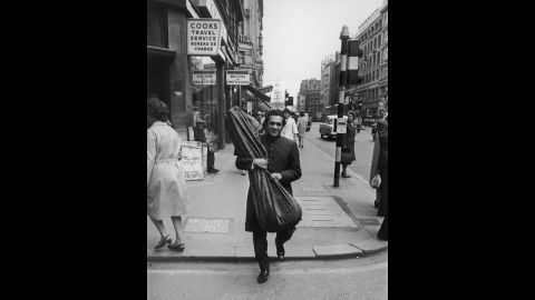 Shankar walks the streets of London with his sitar during a visit circa 1967.