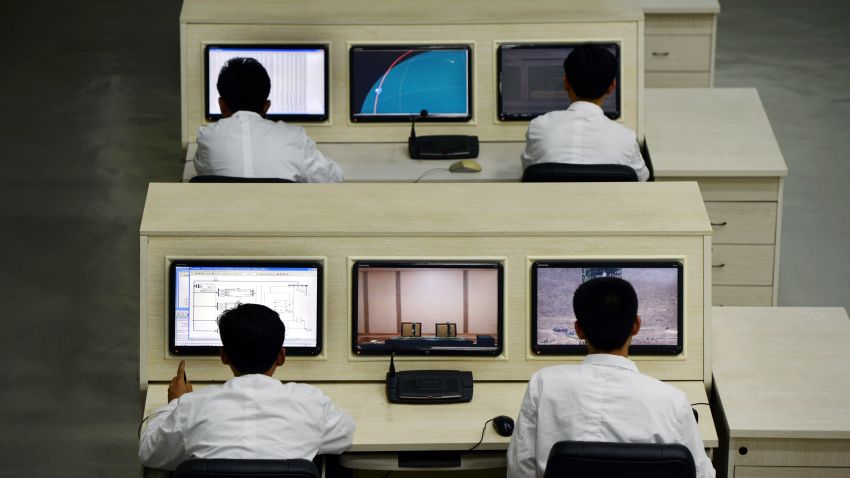 North Korea technicians work at the satellite control room of the space center on the outskirts of Pyongyang on April 11, 2012.