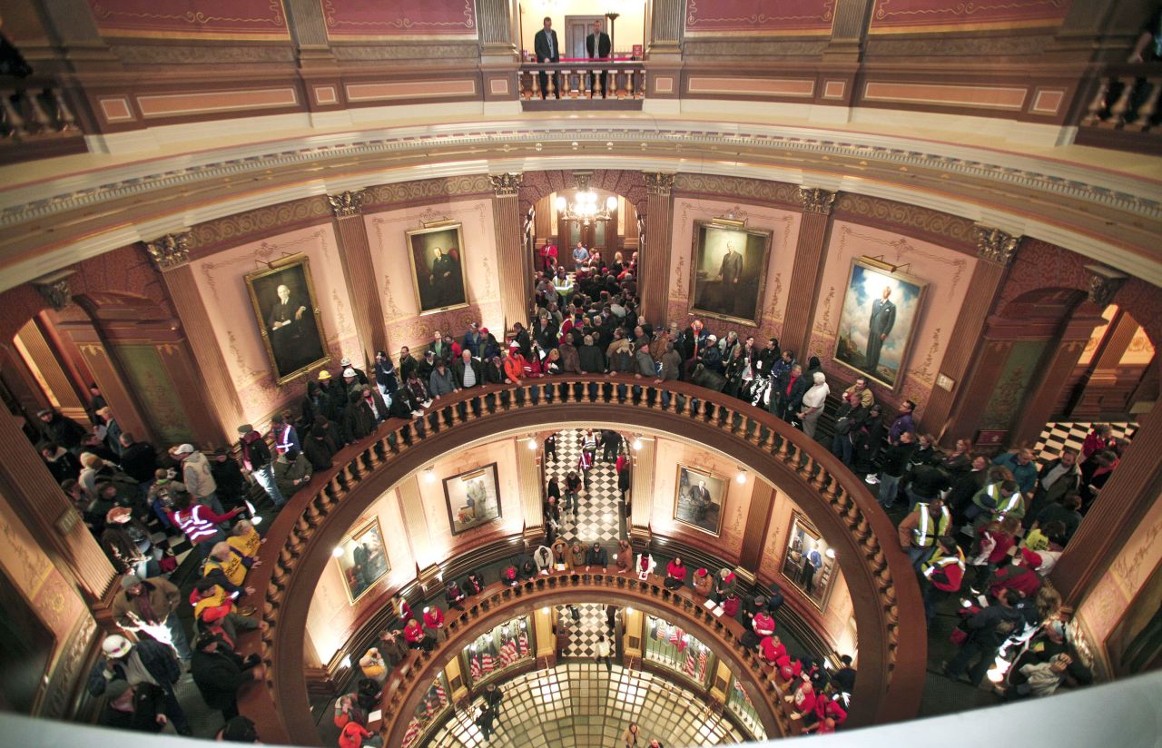 People line up to try to enter the House chamber in the Michigan State Capitol where the bills are voted on.