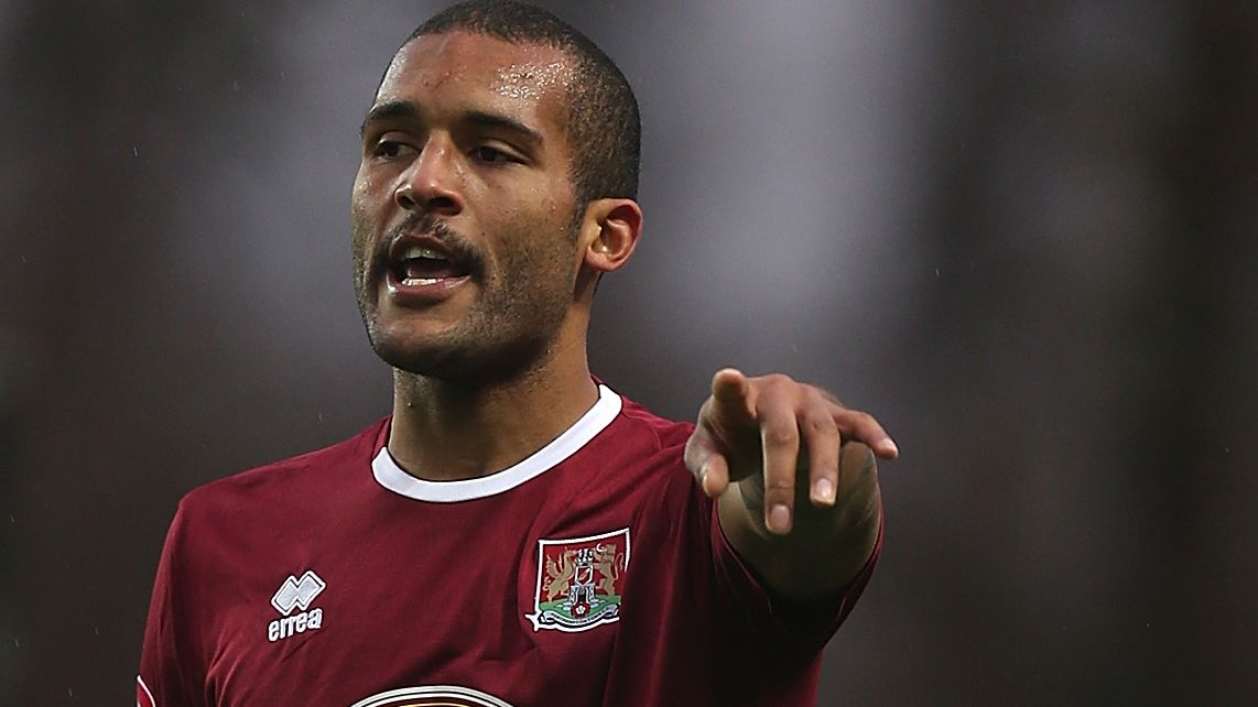 Clarke Carlisle in action playing for Northampton Town in 2012.