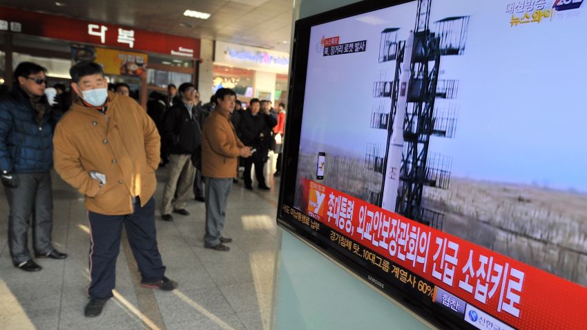 Travellers watch a TV screen broadcasting news about North Korea's rocket launch, at a railway station in Seoul on December 12, 2012. North Korea on December 12 launched a long-range rocket which Japanese authorities said passed over its southern island chain of Okinawa. It was the second launch this year, after a failed attempt in April. AFP PHOTO / JUNG YEON-JE (Photo credit should read JUNG YEON-JE/AFP/Getty Images) 